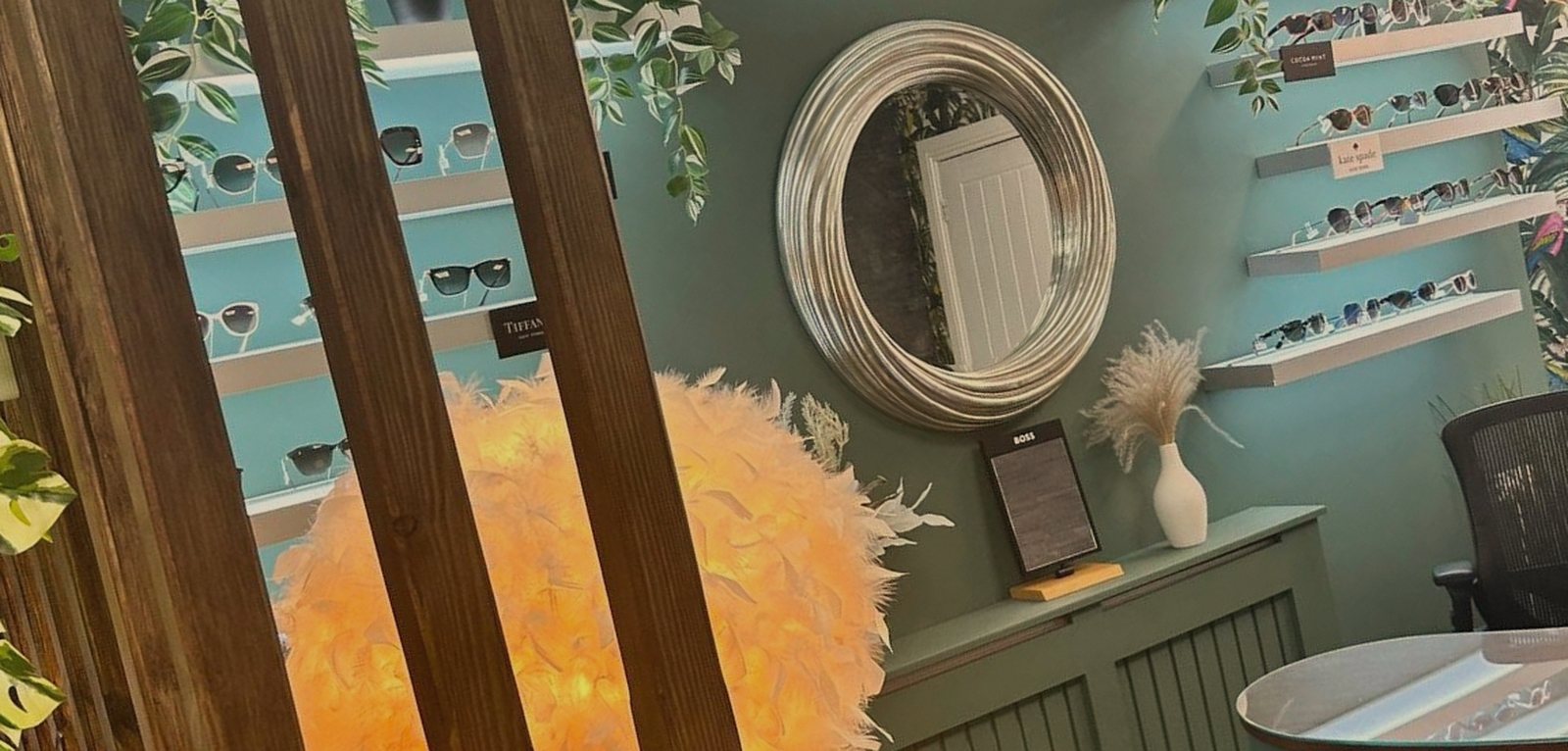 The sunglasses lounge with a glowing feather lamp and gilded mirror