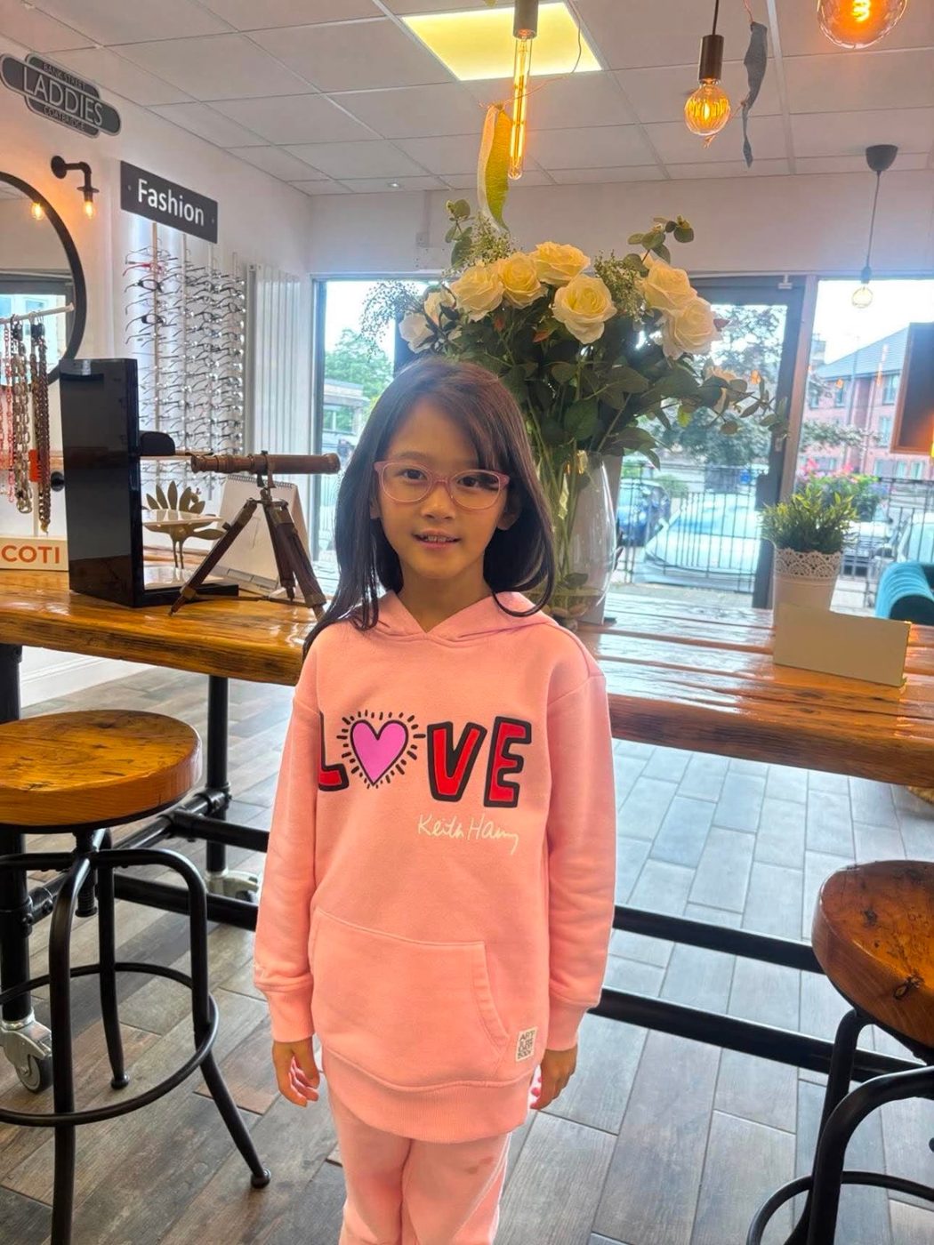 A young patient smiling in her new glasses