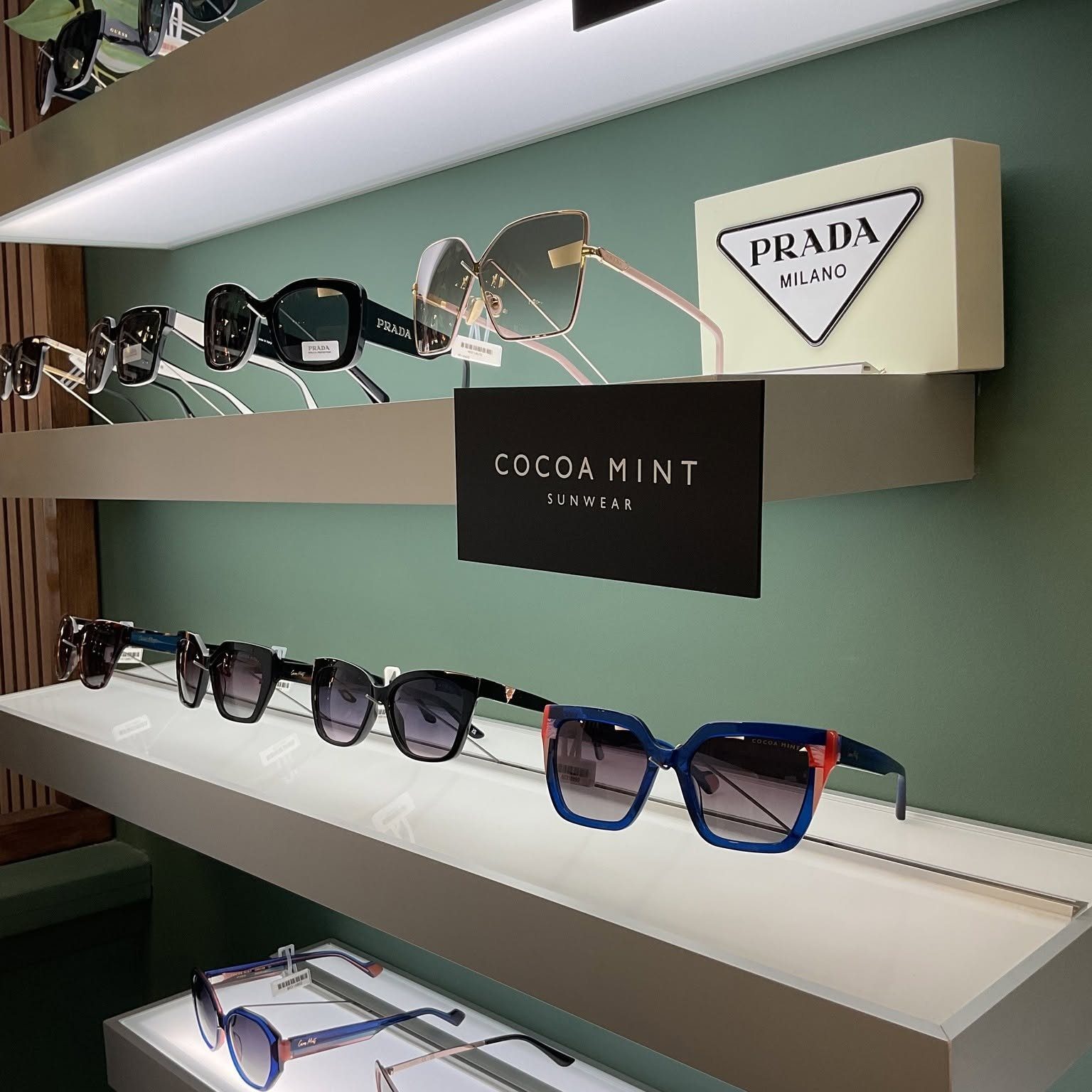 Prada and Cocoa Mint sunglasses on the lounge shelves